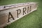 April text on grunge wooden block