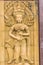 An Apsara dancing carved on the sandstone wall background. Apsara is a female spirit of the clouds and waters in Hindu culture. He