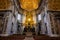 The Apse of Saint Peter`s Basilica Close Up with the golden light of a morning sun lighting up the stain glass window illuminating