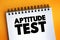 Aptitude Test - assessment used to determine a candidate`s cognitive ability or personality, text concept on notepad