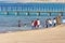 Aqaba, Jordan, March 7, 2018: Children on the beach of Aqaba, fully dressed in the sea bathing and playing