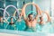 Aqua aerobics exercises, women with male trainer