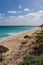 Aqua Caribbean waters and the beach with natural shade umbrellas