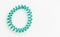 Aqua Menthe spiral rubber band. Elastic hair tie on white background close-up, copy space