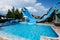 Aqua Paradise Nessebar, Bulgaria - June 19, 2023: Blue water slide in a children\\\'s aquapark on a sunny day