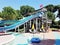 Aqua park with water slides, pool and lounge chairs