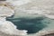 Aqua water of thermal pool in limestone rock of Yellowstone Park, Wyoming.