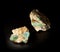 Aquamarine and emerald gemstone crystals inside feldspar rock with molybdenite, mica and apatite inclusions isolated on black