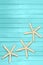 Aquamarine, turquoise, blue boards with starfish and seashell. Travel, summer, spring background. Pier, beach