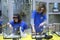 Aquarium husbandry. Girls arranging decorations in an empty aquarium