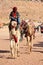 Arab bedouin guide with camels in the ancient city of Petra, jordan