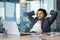 Arab businessman resting inside office on work mask, man with hands behind head with closed eyes dozing and visualizing