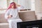 The arab businessman watching tv at home