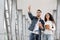 Arab Couple With Passports And Tickets Standing At Airport And Pointing Away