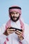 Arab engaging in gaming on smartphone