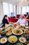 Arab family sitting on a background of dates, raisins and tea waiting for Iftar.