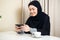 Arab happy casual woman using a smart phone at home