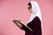 Arab intelligent woman in hijab makes notes