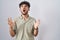 Arab man with beard standing over white background crazy and mad shouting and yelling with aggressive expression and arms raised