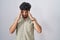 Arab man with beard standing over white background with hand on head, headache because stress