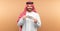 Arab man businessman in national clothes rejoices in dollars in his hands, great profit. Business concept in the middle east, oil