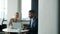 Arab man and Caucasian woman talking and working with laptop sitting at table with coffee