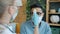 Arab man in face mask talking to doctor at home checking temperature coughing