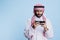 Arab man playing game on smartphone