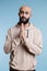 Arab man praying with folded palms