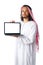 Arab man showing laptop wearing traditional clothes isolated on white