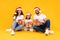 Arab Parents And Little Daughter Holding Christmas Gifts, Yellow Background