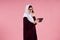 Arab smart woman in hijab speaks on smartphone