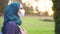 Arab student in hijab wearing glasses and medical bandage in the park