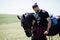 Arab tall beard man wear in black with arabian horse