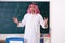 The arab teacher in front of chalkboard