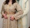 Arab wedding. A groom holds his wife`s waist. The bride wears a traditional Arab dress called the caftan. Henna in the hand