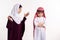 Arab woman in hijab scolds boy in keffiyeh.