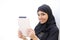 Arab woman holding a tablet and looking at camera