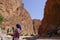 An Arab woman photographed with her phone in the river of The Todra gorges in Morocco