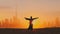 Arab woman rises her hands on Dubai city silhouette with sunset