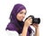 Arab woman wearing a hijab taking a photography