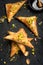 Arabe phyllo sweets. Feta cheese Phyllo Triangles pies with honey and pistachios, selective focus. Cooking sweets turkish, or