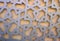 An arabesque aluminium grill abstract in grey and beige