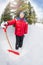 Arabian boy with shovel in winter during day