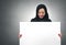 Arabian business woman holding a white board isolated