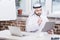 Arabian businessman looking at folder and thinking