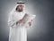 Arabian businessman shocked reading newspaper