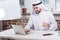 Arabian businessman typing on laptop keyboard