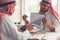 Arabian businessmen are discussing business growth report and be