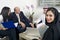 Arabian Businesswoman in office with Businesspeople meeting in the background